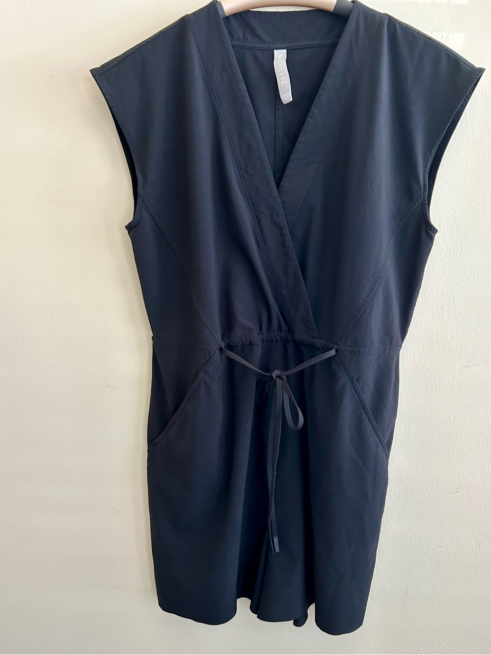 Athleta Sleeveless V-Neck Drawstring Romper in black.